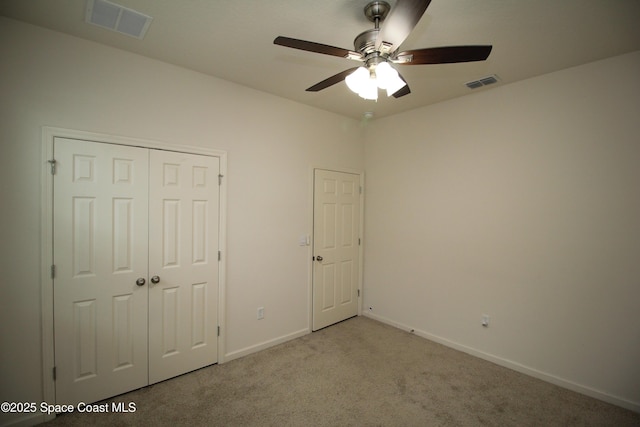 947 Remington Green Dr SE, Palm Bay, FL 32909 - unfurnished bedroom featuring carpet, a closet, and a ceiling fan