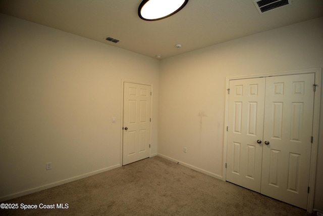 947 Remington Green Dr SE, Palm Bay, FL 32909 - unfurnished bedroom featuring carpet floors and a closet