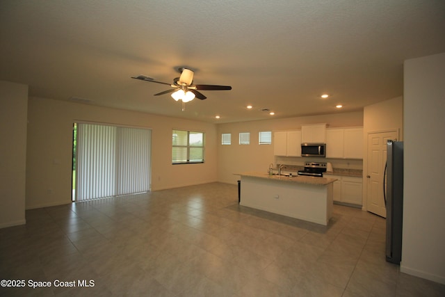 947 Remington Green Dr SE, Palm Bay, FL 32909 - kitchen featuring appliances with stainless steel finishes, open floor plan, ceiling fan, white cabinetry, and recessed lighting