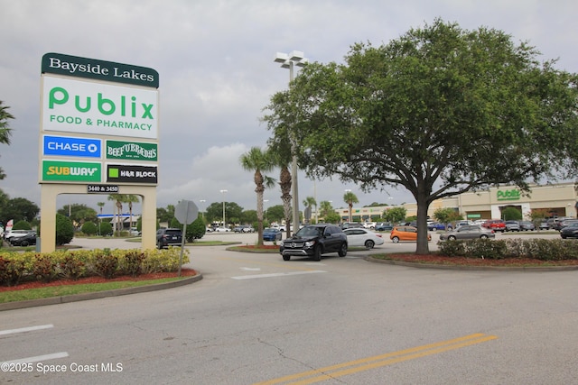 947 Remington Green Dr SE, Palm Bay, FL 32909 - view of asphalt road featuring curbs and traffic signs