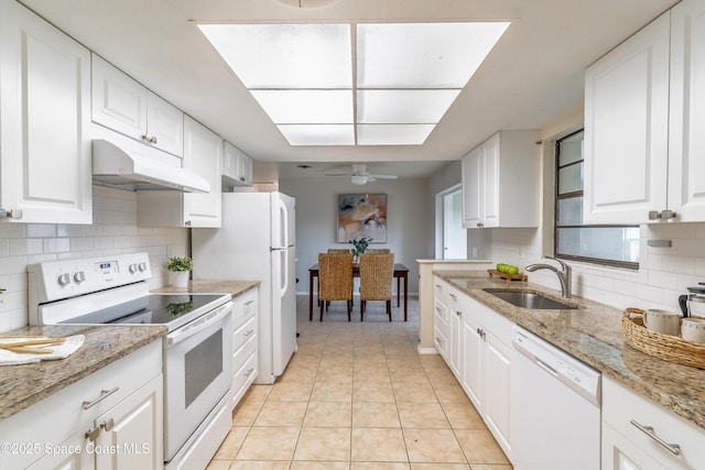 1768 Hudson Cir S, Melbourne, FL 32935 - kitchen with white appliances, under cabinet range hood, white cabinets, decorative backsplash, and a ceiling fan