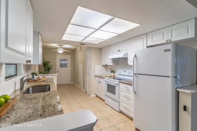 1768 Hudson Cir S, Melbourne, FL 32935 - kitchen featuring white appliances, light tile patterned floors, white cabinetry, under cabinet range hood, and tasteful backsplash