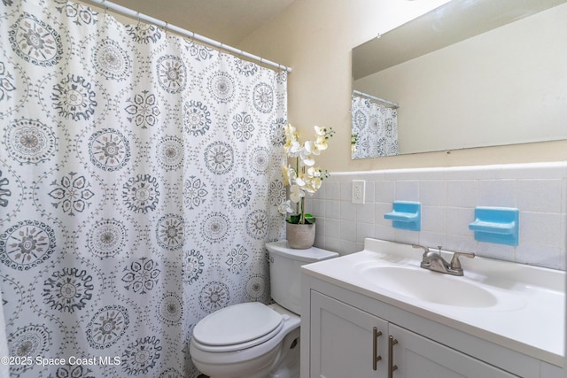 1768 Hudson Cir S, Melbourne, FL 32935 - full bath featuring vanity, tile walls, a wainscoted wall, and a shower with shower curtain