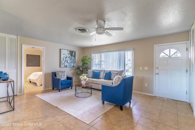 1768 Hudson Cir S, Melbourne, FL 32935 - living area with a ceiling fan, plenty of natural light, light tile patterned flooring, and a textured ceiling