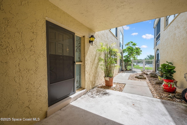 1727 Minutemen Cswy Unit 108, Cocoa Beach, FL 32931 - entrance to property featuring stucco siding, a gate, and a patio