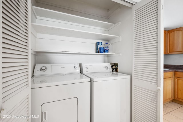 1727 Minutemen Cswy Unit 108, Cocoa Beach, FL 32931 - laundry room featuring washing machine and clothes dryer and light tile patterned flooring