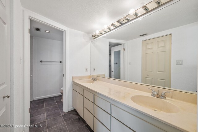 1727 Minutemen Cswy Unit 108, Cocoa Beach, FL 32931 - full bathroom featuring double vanity, tile patterned floors, and a textured ceiling