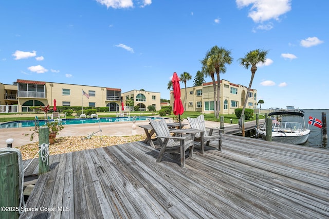 1727 Minutemen Cswy Unit 108, Cocoa Beach, FL 32931 - wooden terrace with a community pool