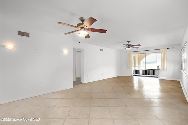 1727 Minutemen Cswy Unit 108, Cocoa Beach, FL 32931 - empty room with radiator, ceiling fan, and light tile patterned flooring