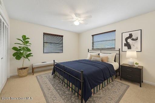 1727 Minutemen Cswy Unit 108, Cocoa Beach, FL 32931 - carpeted bedroom with baseboards and a ceiling fan