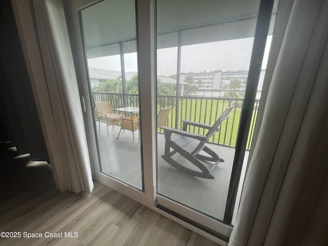 3799 S Banana River Blvd Unit 104, Cocoa Beach, FL 32931 - doorway with light wood-style flooring