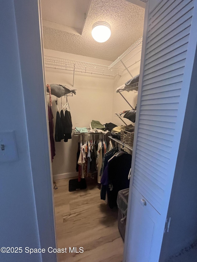3799 S Banana River Blvd Unit 104, Cocoa Beach, FL 32931 - walk in closet featuring wood finished floors