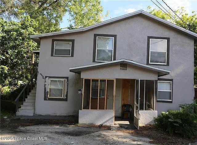 1038 W 10th St, Lakeland, FL 33805 - view of front of property with stucco siding and stairs
