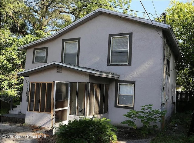 1038 W 10th St, Lakeland, FL 33805 - back of property featuring stucco siding and a sunroom