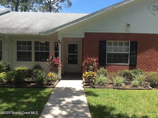 33 Kings Colony Ct, Palm Coast, FL 32137 - property entrance with brick siding and roof with shingles