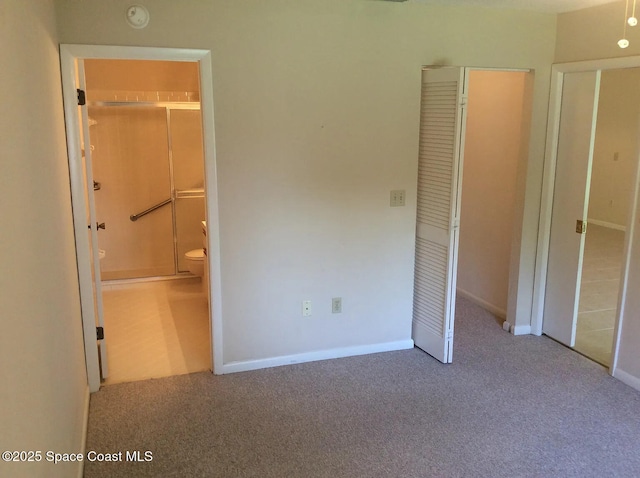 33 Kings Colony Ct, Palm Coast, FL 32137 - unfurnished bedroom featuring carpet, ensuite bathroom, and a closet