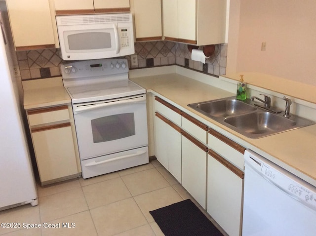 33 Kings Colony Ct, Palm Coast, FL 32137 - kitchen with white appliances, tasteful backsplash, light countertops, and white cabinets