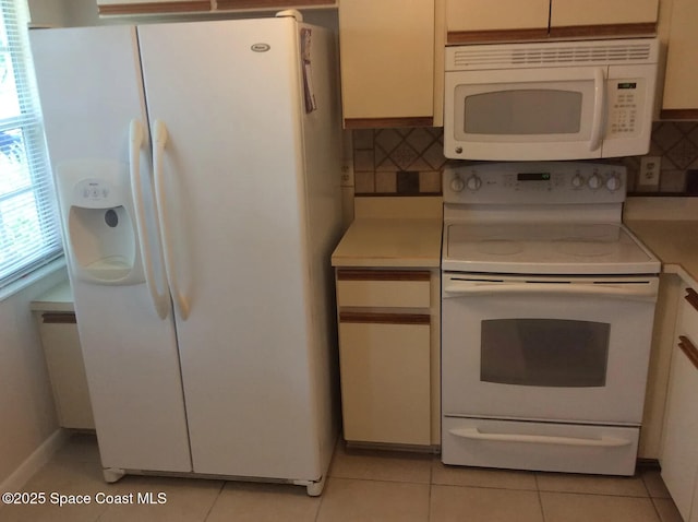 33 Kings Colony Ct, Palm Coast, FL 32137 - kitchen featuring white appliances, light countertops, tasteful backsplash, and light tile patterned floors