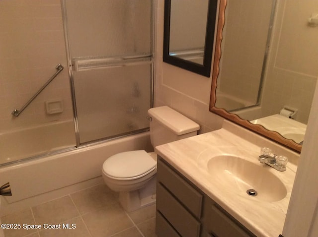 33 Kings Colony Ct, Palm Coast, FL 32137 - full bath with tile patterned flooring, vanity, and bath / shower combo with glass door