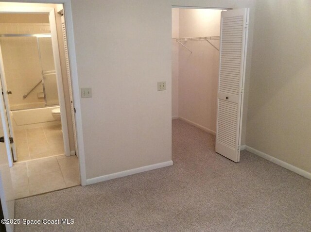 33 Kings Colony Ct, Palm Coast, FL 32137 - unfurnished bedroom with a closet, carpet, and ensuite bathroom