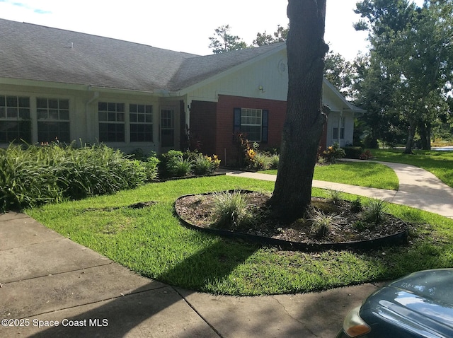 33 Kings Colony Ct, Palm Coast, FL 32137 - view of home's exterior featuring a yard and brick siding