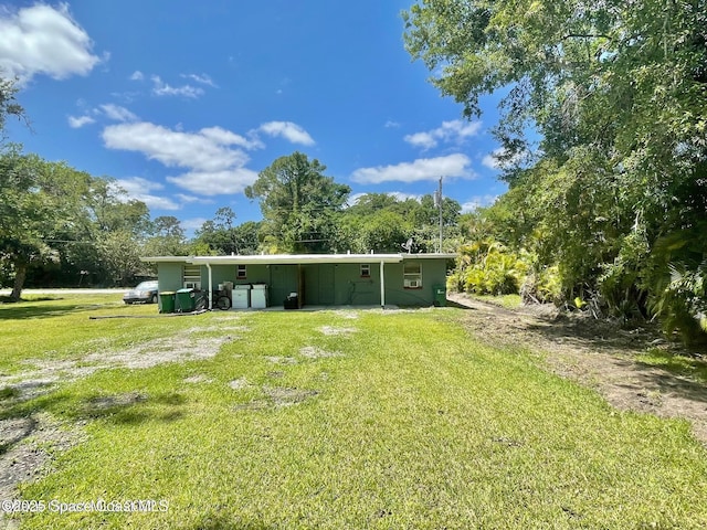 316 Bay Ave, Cocoa, FL 32922 - rear view of property featuring a lawn and view of scattered trees