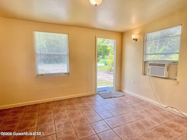 316 Bay Ave, Cocoa, FL 32922 - doorway featuring tile patterned floors, cooling unit, and a textured ceiling