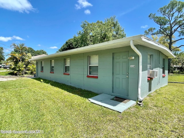 316 Bay Ave, Cocoa, FL 32922 - view of home's exterior featuring a yard and concrete block siding