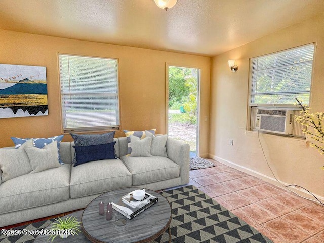 316 Bay Ave, Cocoa, FL 32922 - living area featuring tile patterned flooring, a textured ceiling, and cooling unit