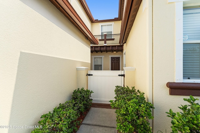 2032 Elkins Pt, Melbourne, FL 32935 - property entrance with stucco siding and a balcony