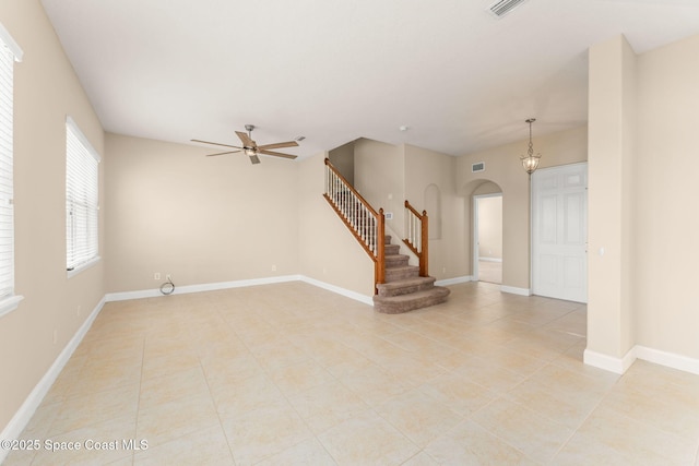 2032 Elkins Pt, Melbourne, FL 32935 - unfurnished room featuring arched walkways, a ceiling fan, stairway, and light tile patterned floors