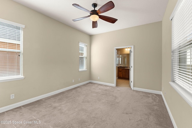 2032 Elkins Pt, Melbourne, FL 32935 - spare room with light carpet, a ceiling fan, and plenty of natural light