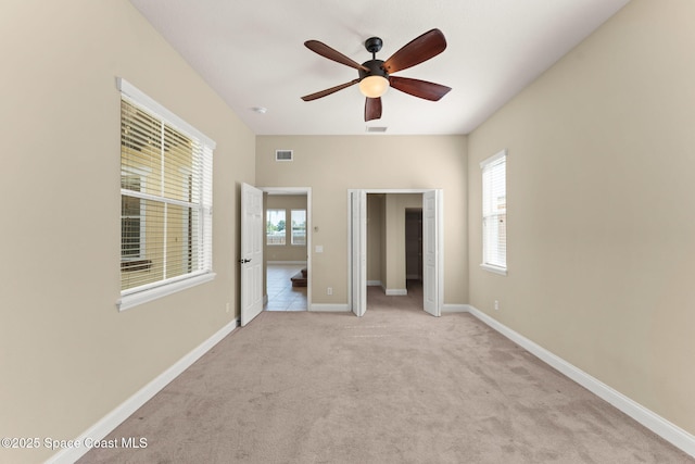 2032 Elkins Pt, Melbourne, FL 32935 - unfurnished bedroom featuring multiple windows, carpet, a ceiling fan, and a closet