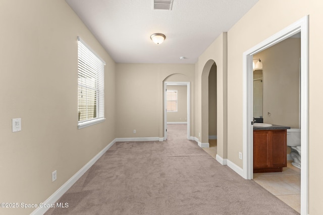 2032 Elkins Pt, Melbourne, FL 32935 - unfurnished room featuring light colored carpet and arched walkways