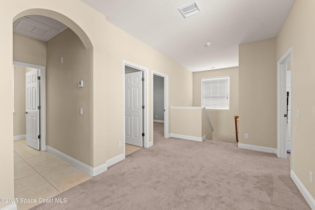 2032 Elkins Pt, Melbourne, FL 32935 - spare room with arched walkways and light colored carpet