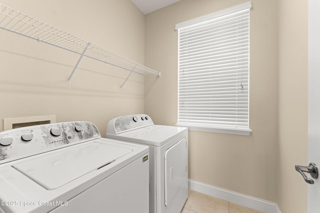 2032 Elkins Pt, Melbourne, FL 32935 - washroom featuring washer and clothes dryer and light tile patterned flooring