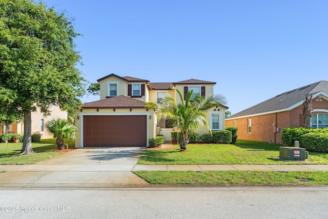 2032 Elkins Pt, Melbourne, FL 32935 - view of front of home featuring stucco siding, a garage, concrete driveway, and a front yard