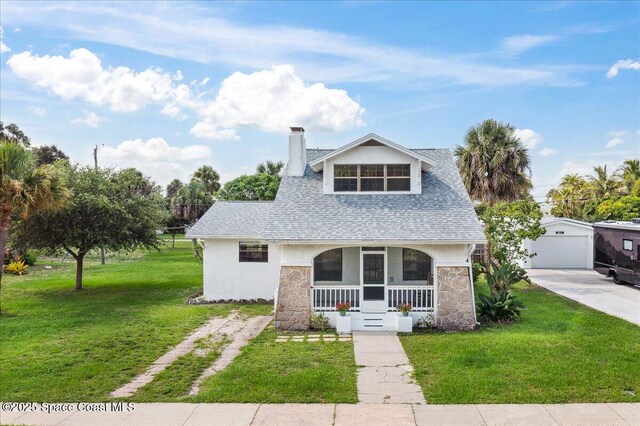 415 2nd Ave, Indialantic, FL 32903 - view of front of house with stone siding, concrete driveway, a porch, a chimney, and an outdoor structure