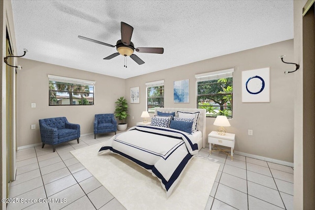 415 2nd Ave, Indialantic, FL 32903 - bedroom with light tile patterned floors, a textured ceiling, and a ceiling fan