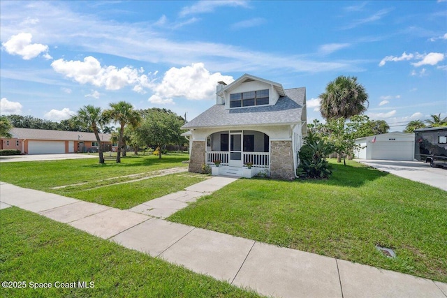 415 2nd Ave, Indialantic, FL 32903 - view of front of property with a porch, concrete driveway, and a front yard