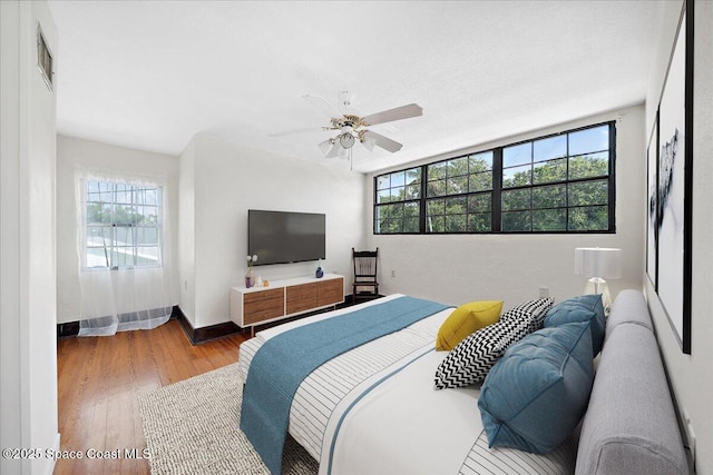 415 2nd Ave, Indialantic, FL 32903 - bedroom with multiple windows, wood finished floors, and a ceiling fan