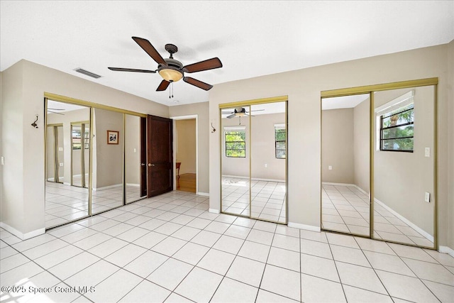 415 2nd Ave, Indialantic, FL 32903 - unfurnished bedroom with two closets, light tile patterned floors, and ceiling fan