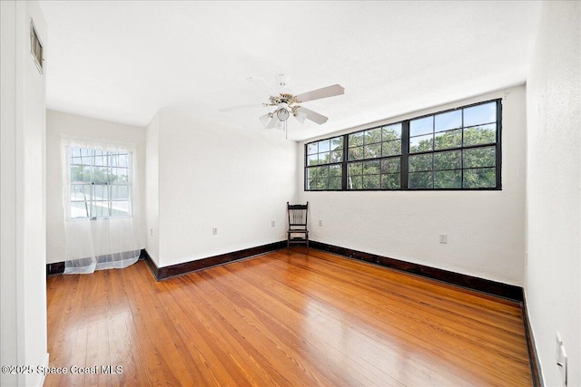 415 2nd Ave, Indialantic, FL 32903 - empty room with plenty of natural light, wood finished floors, and ceiling fan