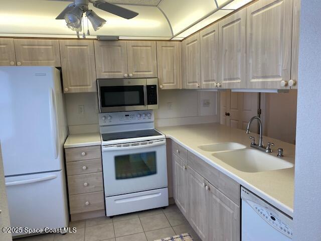 2727 N Wickham Rd # 106-7, Melbourne, FL 32935 - kitchen featuring white appliances, light tile patterned flooring, a ceiling fan, and light countertops