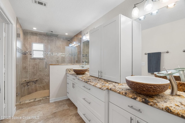 1036 Greenleaf Ct, Rockledge, FL 32955 - bathroom with double vanity, walk in shower, and a textured ceiling