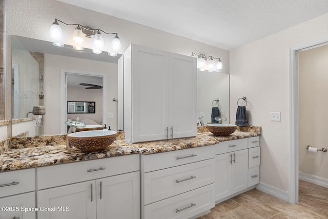 1036 Greenleaf Ct, Rockledge, FL 32955 - bathroom featuring vanity, ensuite bath, a tile shower, and a textured wall