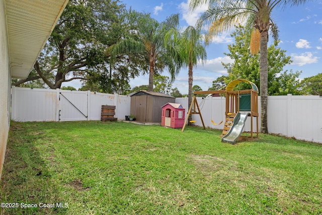 1036 Greenleaf Ct, Rockledge, FL 32955 - fenced backyard featuring a gate, a storage shed, and a playground
