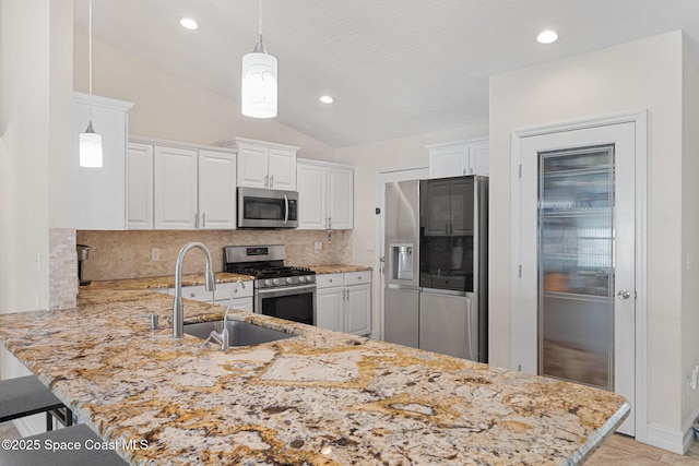 1036 Greenleaf Ct, Rockledge, FL 32955 - kitchen with stainless steel appliances, a peninsula, lofted ceiling, tasteful backsplash, and white cabinets