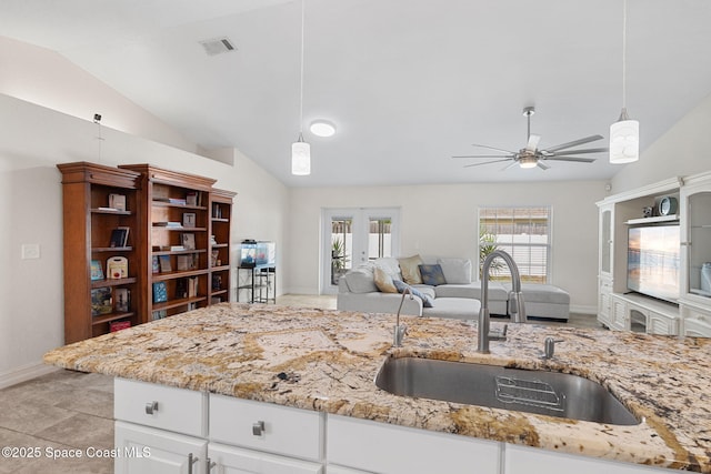 1036 Greenleaf Ct, Rockledge, FL 32955 - kitchen featuring lofted ceiling, ceiling fan, hanging light fixtures, open floor plan, and white cabinetry