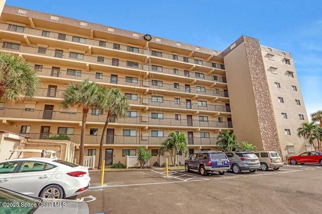 3170 N Atlantic Ave N Unit 403, Cocoa Beach, FL 32931 - view of apartment building / complex with uncovered parking